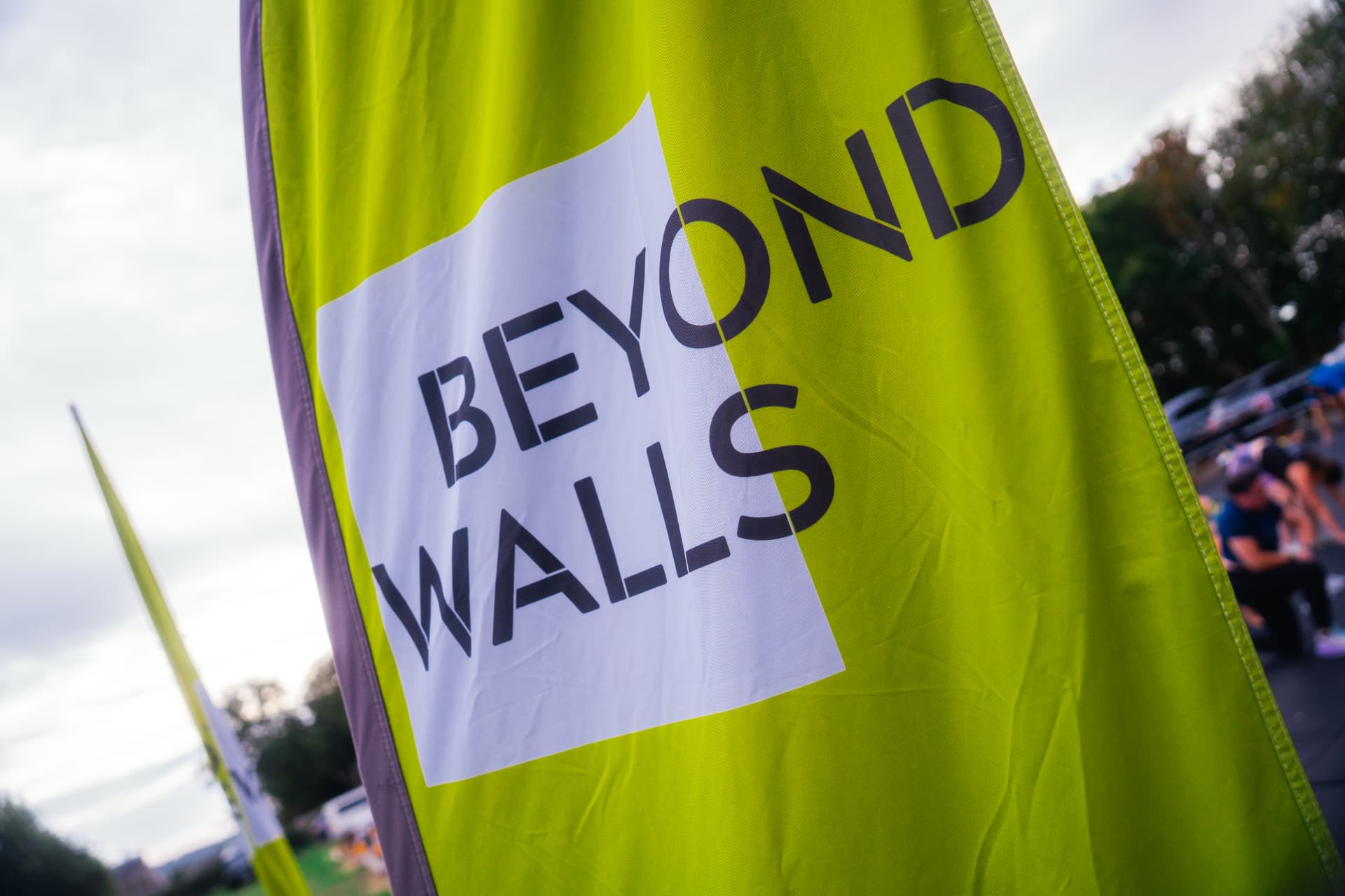 A Beyond Walls flag against the sky