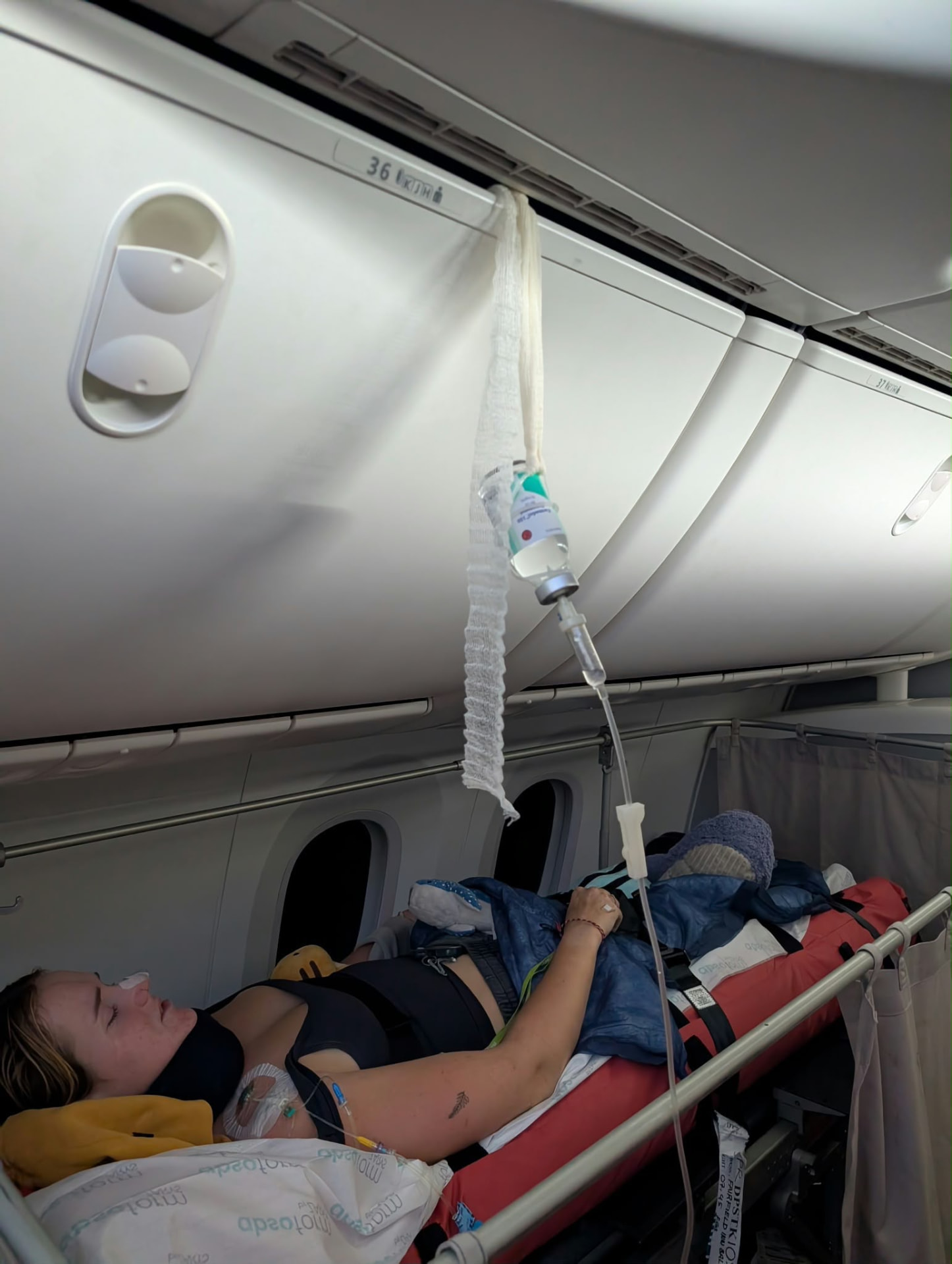 Georgia receiving care on a stretcher during the flight