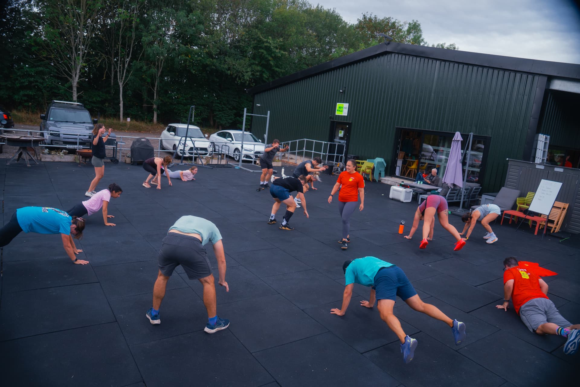 A class training on the outdoor mats beside the Beyond Walls gym