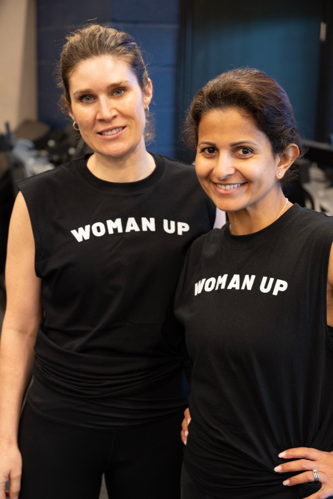 Two members in Woman Up tees