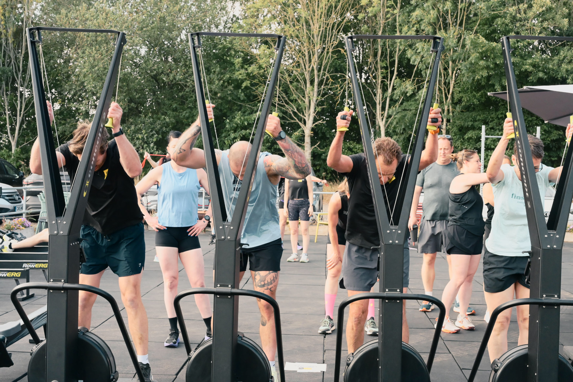 Beyond Walls members training on the ski ergs outside the gym