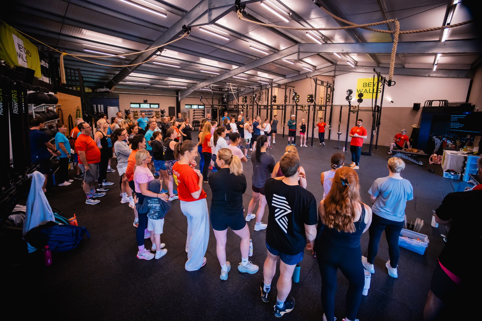 A packed Beyond Walls gym during a group session briefing