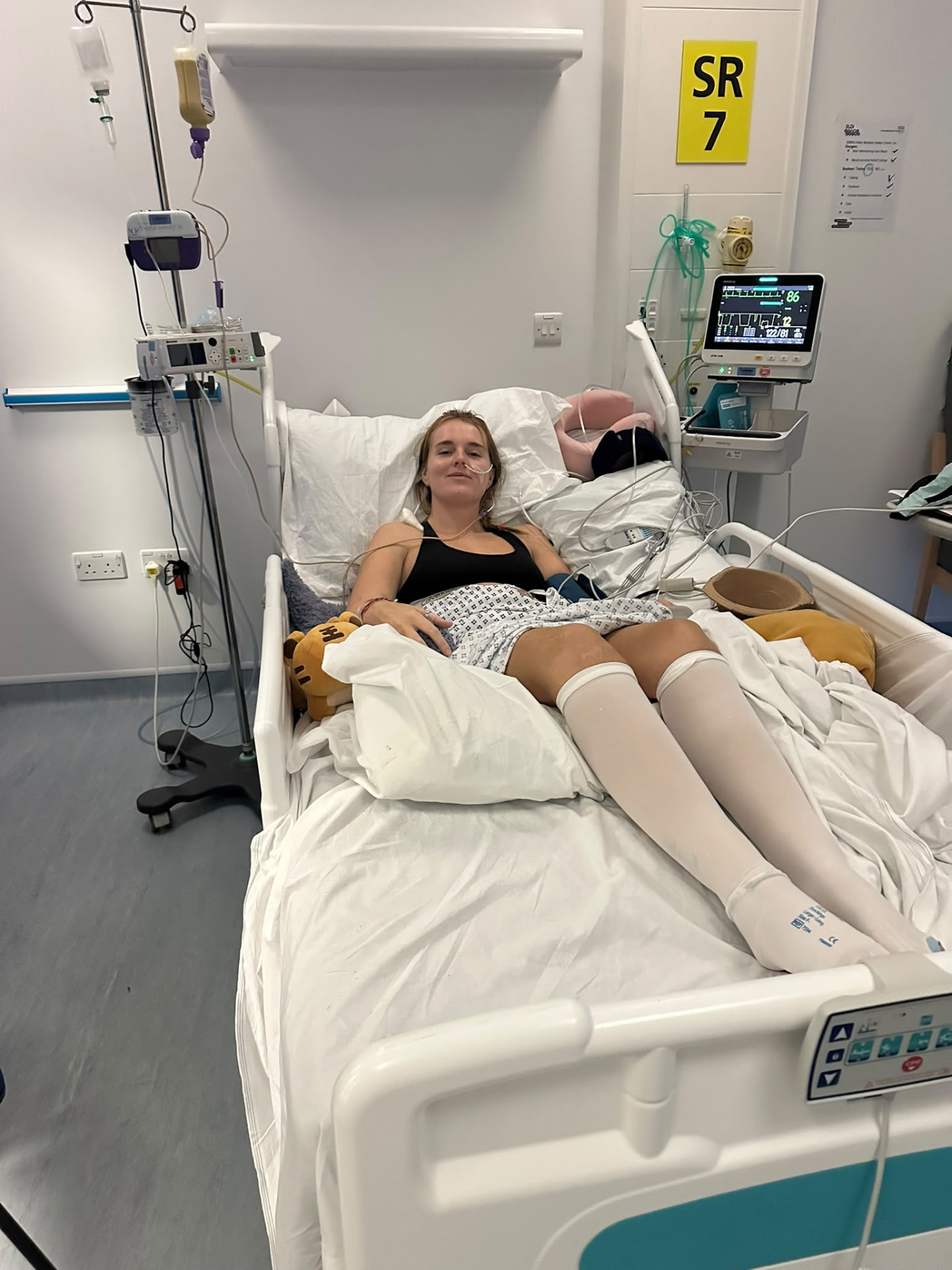 A wider view of Georgia sitting up in her hospital bed