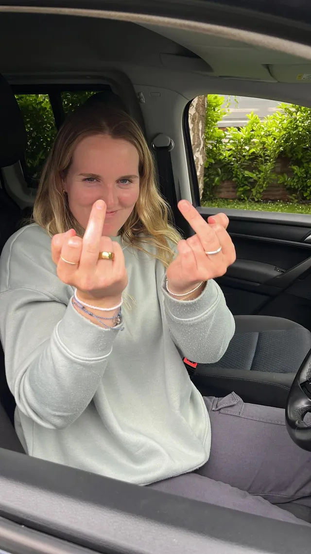 Georgia making a playful gesture from a car seat