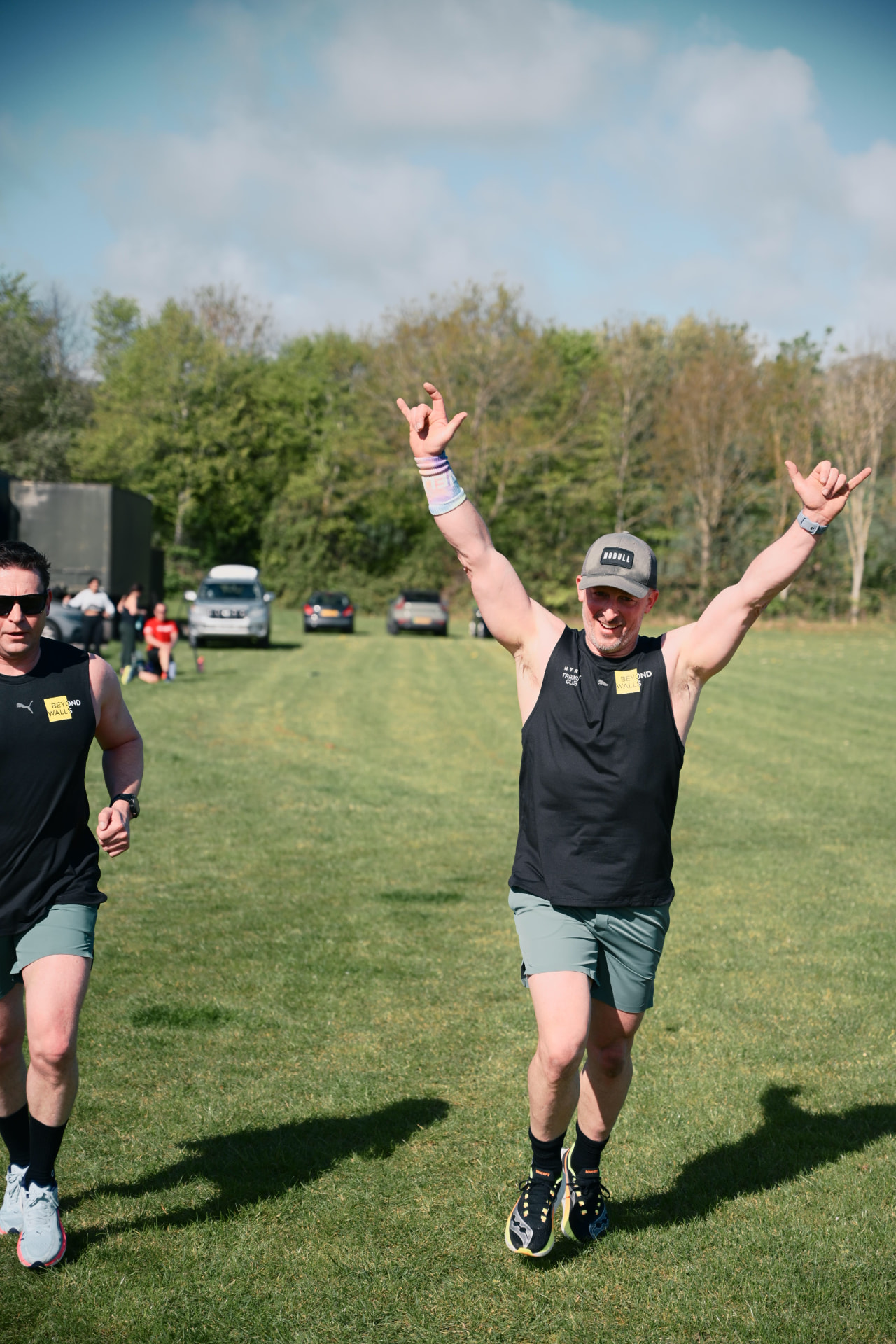 A member celebrating with arms raised on the field