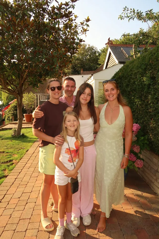 Georgia smiling with a group of people in a sunny garden