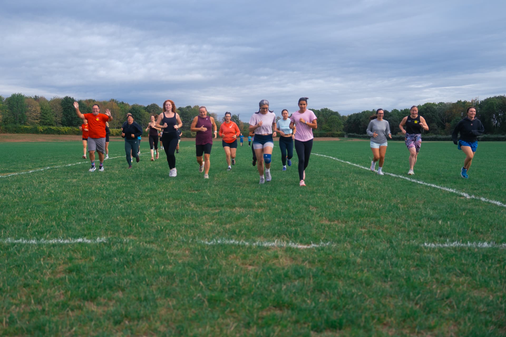 Members running across the open field at Lower Mount Farm, Cookham