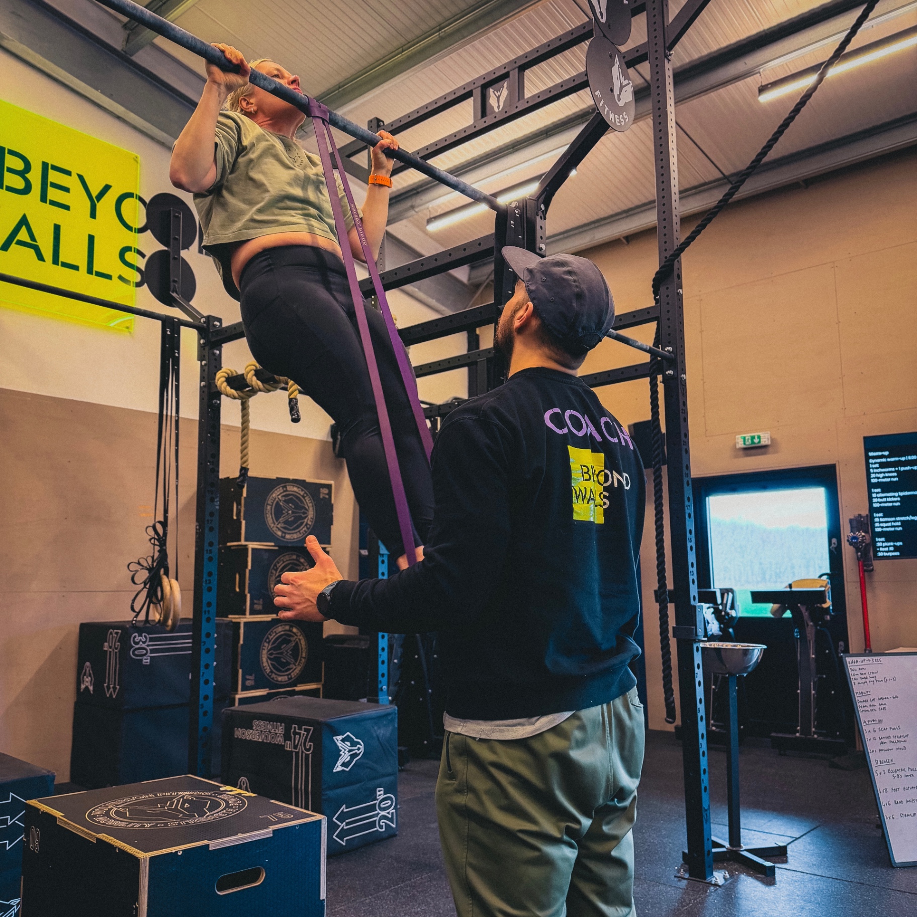 Athlete training rings under coach guidance