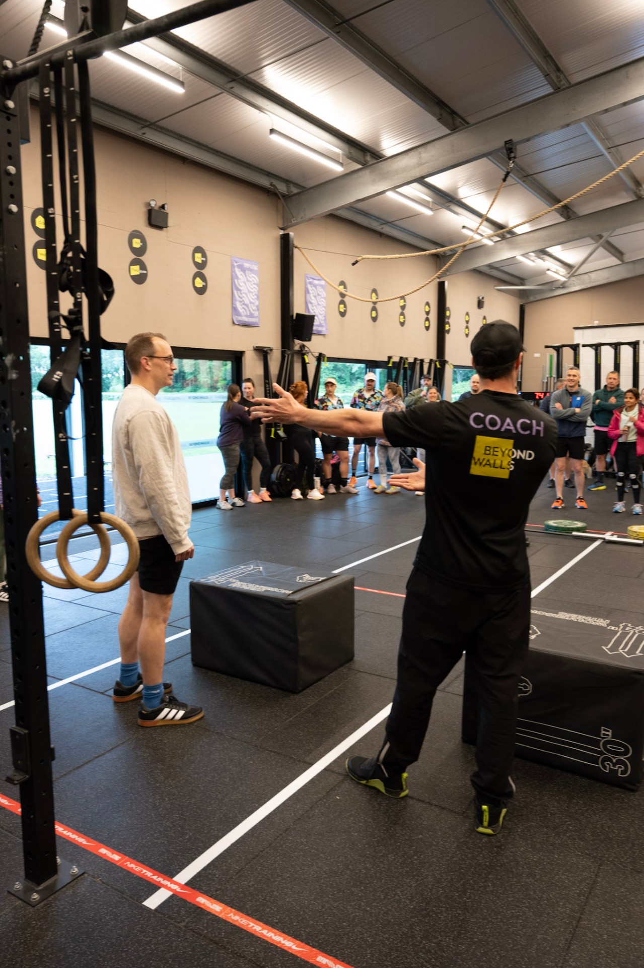 A Beyond Walls coach giving a member a coaching cue during a session